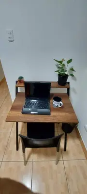 a laptop computer sitting on a wooden table at Warmisitay H O M E in Lima