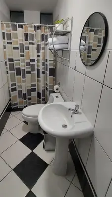 a bathroom with a toilet and a sink and a mirror at Warmisitay H O M E in Lima