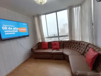 a living room with a couch and a tv at Apartment 03 dormitorios San Miguel in Lima