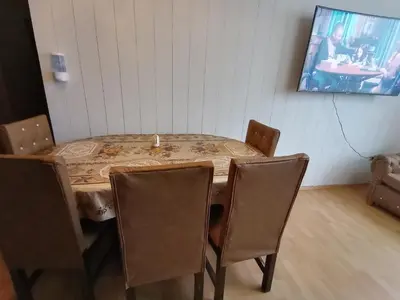 a table with chairs and a candle on top of it at Apartment 03 dormitorios San Miguel in Lima