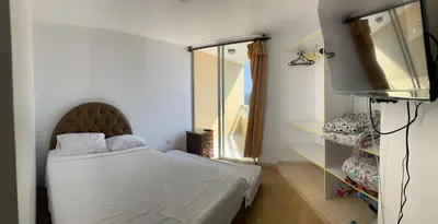 a bedroom with a bed and a television in it at Apartment 03 dormitorios San Miguel in Lima
