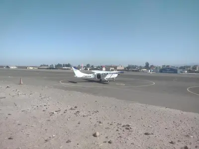 a small plane is sitting on a runway at 420 Route's Backpackers in Nazca