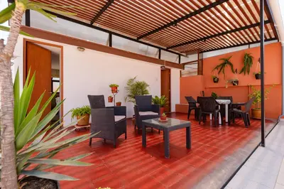 a patio with tables and chairs in a building at Charming Miraflores Guesthouse with Terrace Studio Apartment and Private Room in Lima
