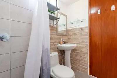 a bathroom with a white toilet and a sink at Charming Miraflores Guesthouse with Terrace Studio Apartment and Private Room in Lima