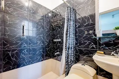 a bathroom with a shower and a toilet and a sink at Charming Miraflores Guesthouse with Terrace Studio Apartment and Private Room in Lima