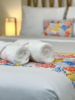 a towel laying on top of a bed at Atoq Paracas Reserva in Paracas