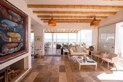 a living room with a couch and a fireplace at Atoq Paracas Reserva in Paracas