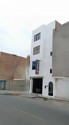 a white building on the side of a street at Hostal Venus - Nueva Imagen in Huacho