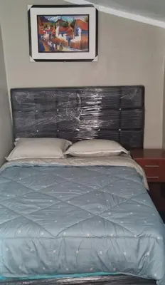 a bed in a bedroom with a head board at CASA HOSPEDAJE LA FLORIDA in Cusco