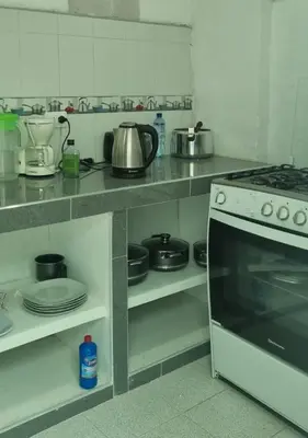 a kitchen with a stove and a counter with pots and pans at CASA HOSPEDAJE LA FLORIDA in Cusco