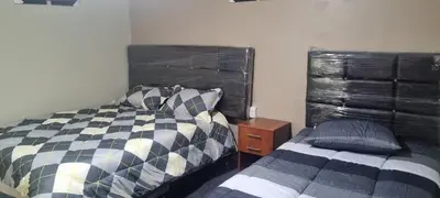 a bedroom with a bed and a nightstand next to a bed sidx sidx sidx at CASA HOSPEDAJE LA FLORIDA in Cusco