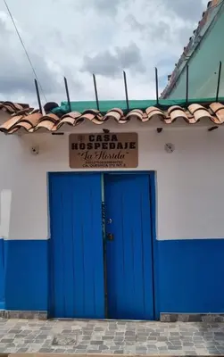a building with a blue door with a sign above it at CASA HOSPEDAJE LA FLORIDA in Cusco