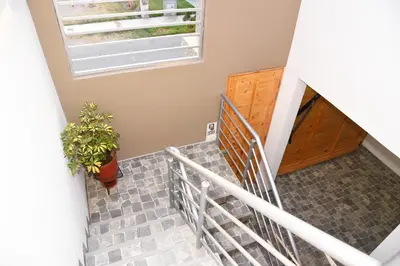 a staircase in a house with a potted plant at Departamento Moderno - Zona Exclusiva - Huacachina in Ica