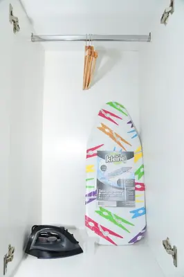 a surfboard on a shelf next to a phone at Departamento Moderno - Zona Exclusiva - Huacachina in Ica