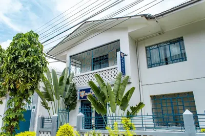 a white building with plants in front of it at Casa Plaza Bolivar in Quillabamba
