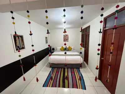 a bedroom with a bed and a colorful rug at Hotel Perumanta Boutique in Cusco