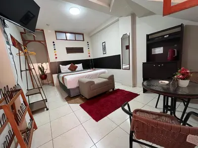 a bedroom with a bed and a table in a room at Hotel Perumanta Boutique in Cusco