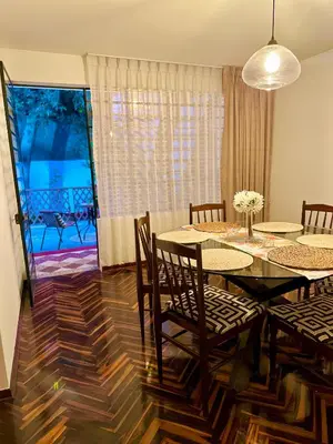 a dining room with a table and chairs and a balcony at Casa Verde Jesús María - Zona Residencial in Lima