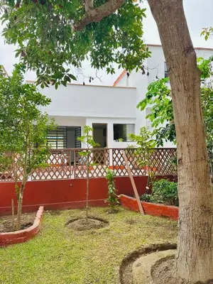 a house with a tree in the yard at Casa Verde Jesús María - Zona Residencial in Lima