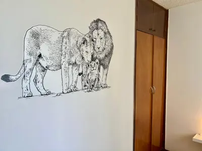a drawing of three lions on a wall at Pershing, depa bonito, 3camas wifi/cable in Lima