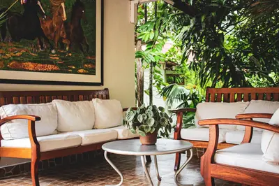a living room with a couch and two chairs and a table at Albergue Turístico Gstir in Pozuzo