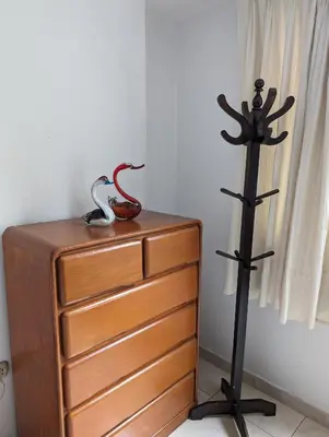 a wooden dresser with a statue on top of it at Apartamento Privado, cerca al Centro Histórico de Lima in Lima