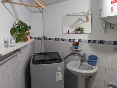 a small bathroom with a sink and a trash can at Apartamento Privado, cerca al Centro Histórico de Lima in Lima