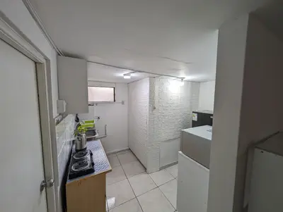 a small kitchen with a sink and a stove at Apartamento Privado, cerca al Centro Histórico de Lima in Lima