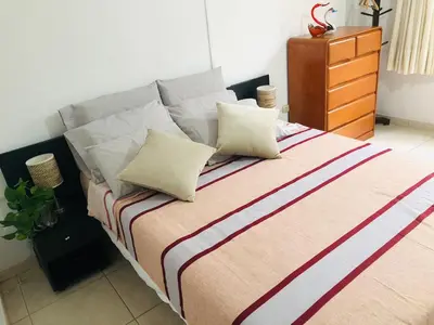 a bed with two pillows and a dresser in a bedroom at Apartamento Privado, cerca al Centro Histórico de Lima in Lima
