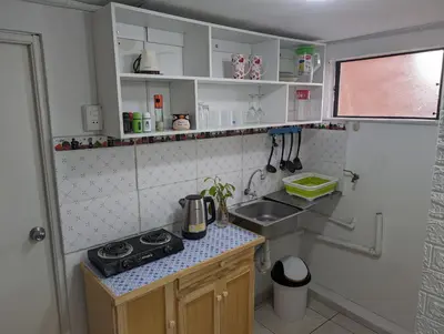 a small kitchen with a stove and a sink at Apartamento Privado, cerca al Centro Histórico de Lima in Lima