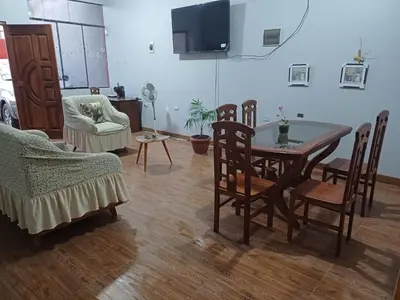 a living room with a dining room table and chairs at MI SELVA Y SU ENCANTO in La Merced