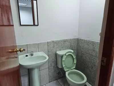 a bathroom with a toilet and a sink at COZZY APARTMENT IN AYACUCHO in Ayacucho