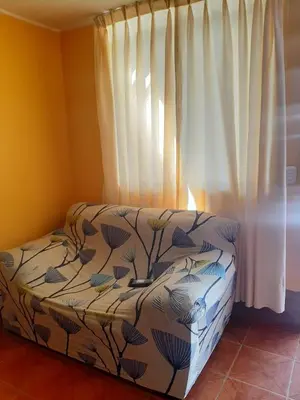 a bedroom with a bed and a window with curtains at Casa La Ruta Pisco in Pisco