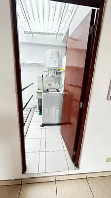 an open door to a kitchen with a refrigerator at Hermoso Apartamento Miraflores Central in Lima