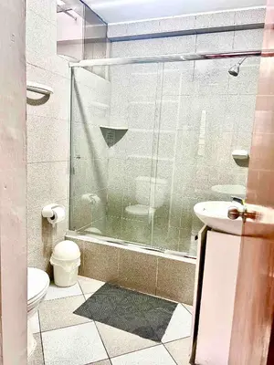 a bathroom with a shower and a toilet and a sink at Hermoso Apartamento Miraflores Central in Lima