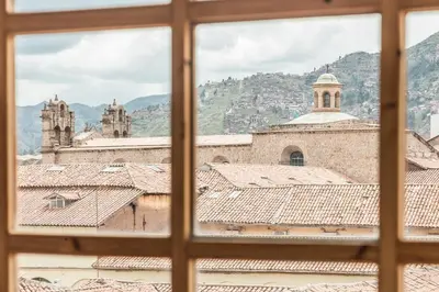 a view of the roofs of the buildings seen through a window at SAMANA B&B in Cusco
