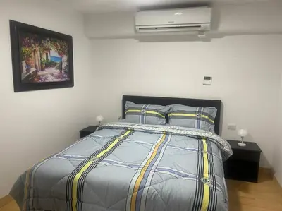 a bed with a comforter and pillows in a bedroom at (25) Dpto con inmejorable ubicación en Miraflores in Lima