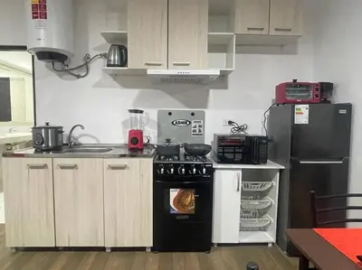 a kitchen with a stove and a refrigerator at (25) Dpto con inmejorable ubicación en Miraflores in Lima