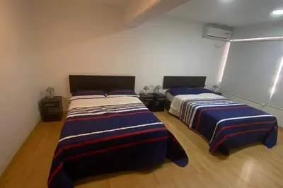 a bedroom with two beds and a window at (29) Dpto Nuevo y Acogedor Miraflores in Lima