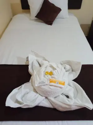 a pile of towels sitting on top of a bed at La Casita de Gabriel in Cusco