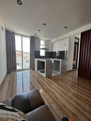 a living room with a couch and a hard wood floor at Hotel SOGU TOWER in Ayacucho