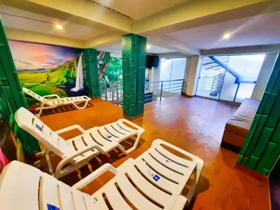 a room with chairs and a mural on the wall at Brianny Hotel in Churín