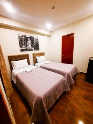 two beds in a hotel room with two at Brianny Hotel in Churín