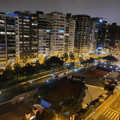a tennis court in the middle of a city at night at The Guest House 1 at the booming center of Miraflores, Lima - Peru in Lima