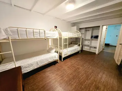 a room with two bunk beds and a wooden floor at Duplex MyM in Lima