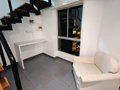 a living room with a couch and a window at Duplex MyM in Lima