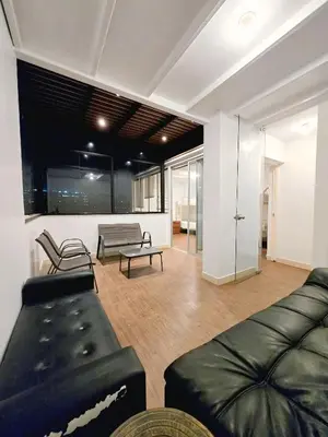 a living room with a couch and a table at Duplex MyM in Lima