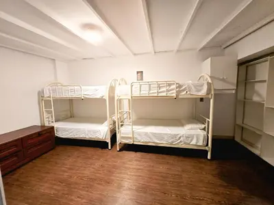 two bunk beds in a room with a wooden floor at Duplex MyM in Lima