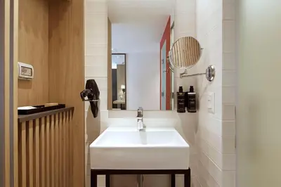 a bathroom with a white sink and a mirror at Ikonik Miraflores in Lima