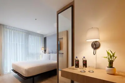 a hotel room with a bed and a mirror at Ikonik Miraflores in Lima